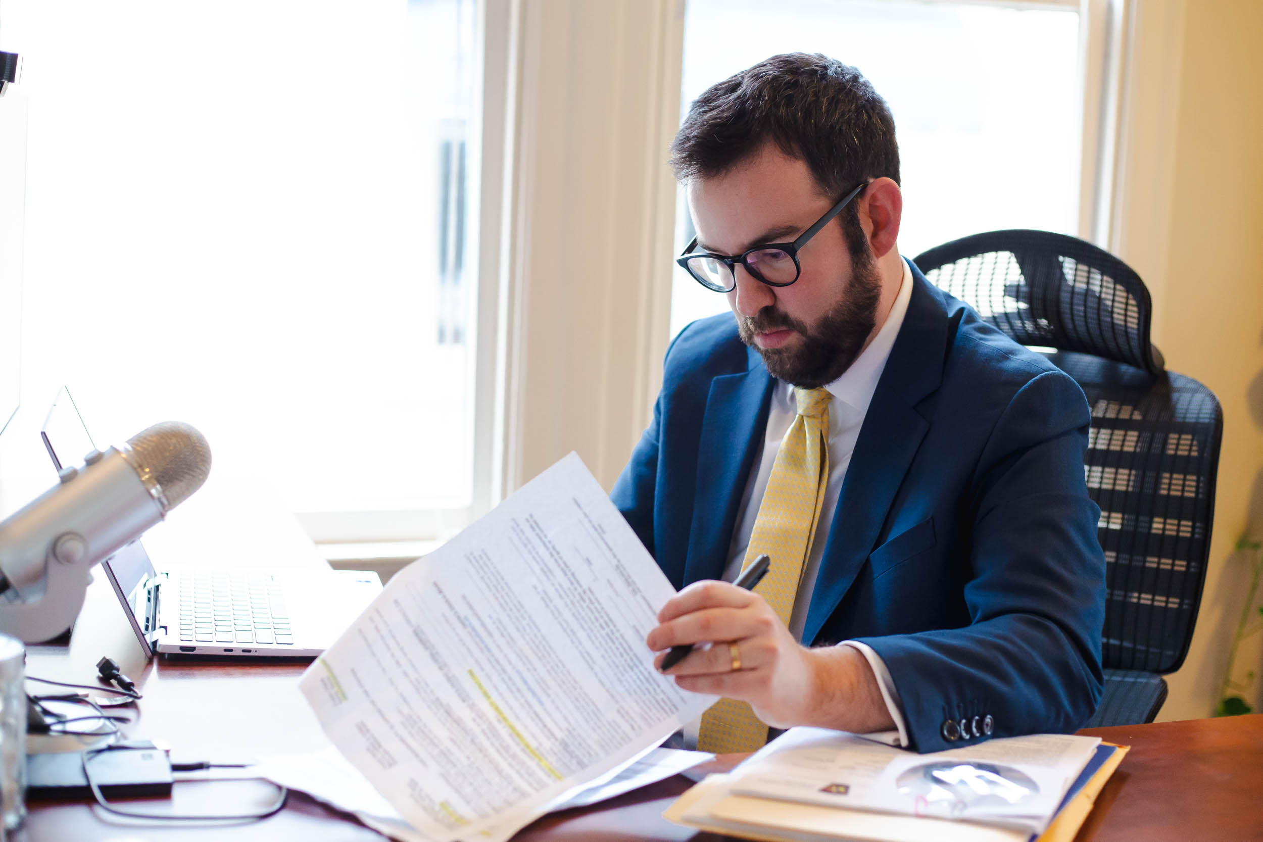 Zachary Bidner at desk with legal documents